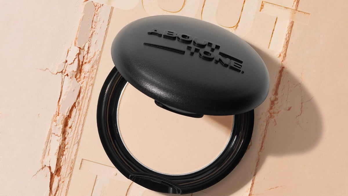 Compact with ABOUT TONE logo showcasing Enhance Your Natural Beauty with ABOUT TONE's Tailored Cosmetics.