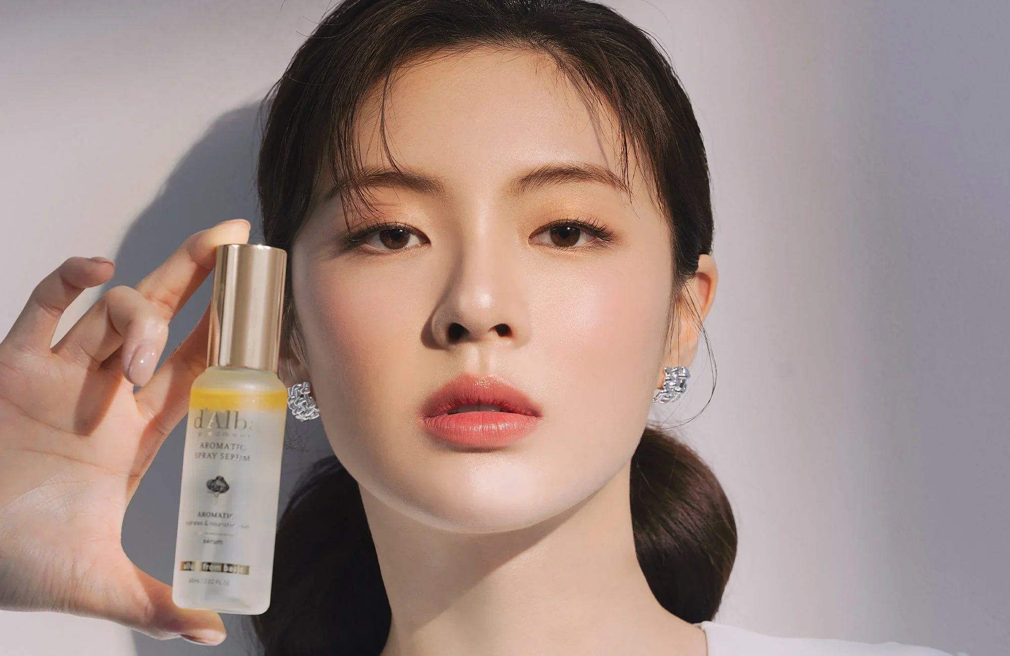 Woman holding D'ALABA serum, Discovering the Elegance: Embracing the Essence of Korean Skincare with D'ALABA