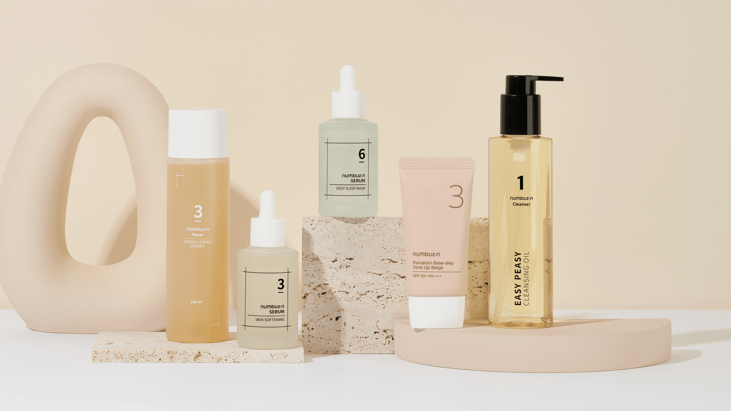 Exploring the Korean Beauty Brand NUMBUZIN: A Comprehensive Guide featuring NUMBUZIN skincare products displayed on a stylish arrangement.