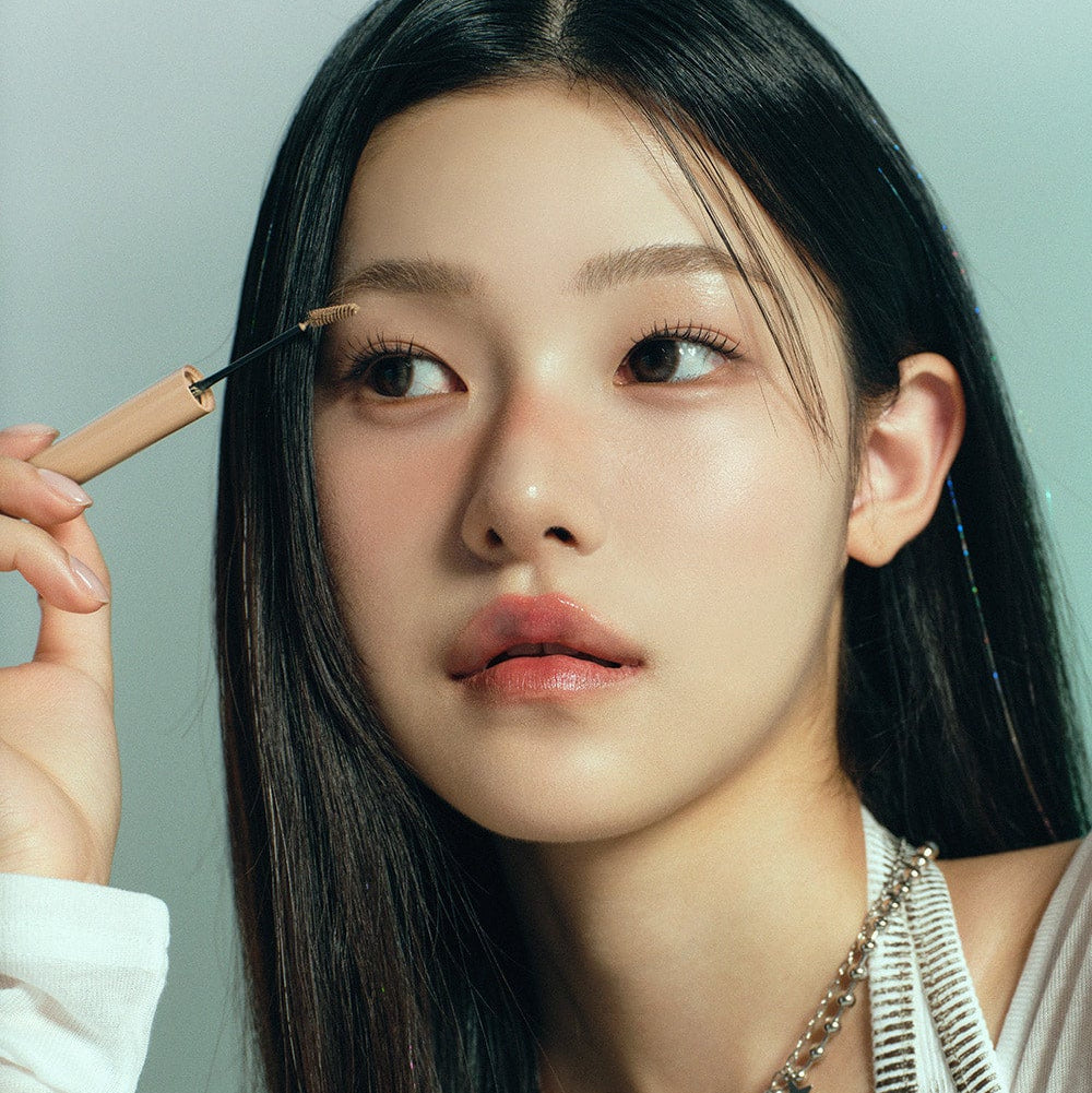 Woman applying HEART PERCENT Dot On Mood Fake Up Brow Cara to eyebrows; close-up view of product usage.