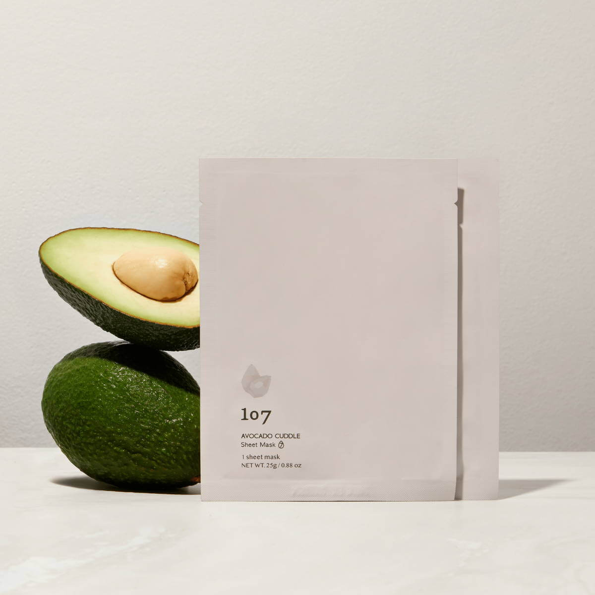 107 Avocado Curd Sheets Mask 5 Pieces with fresh avocados in background, ideal for nourishing skincare, moisturizing and hydrating face mask