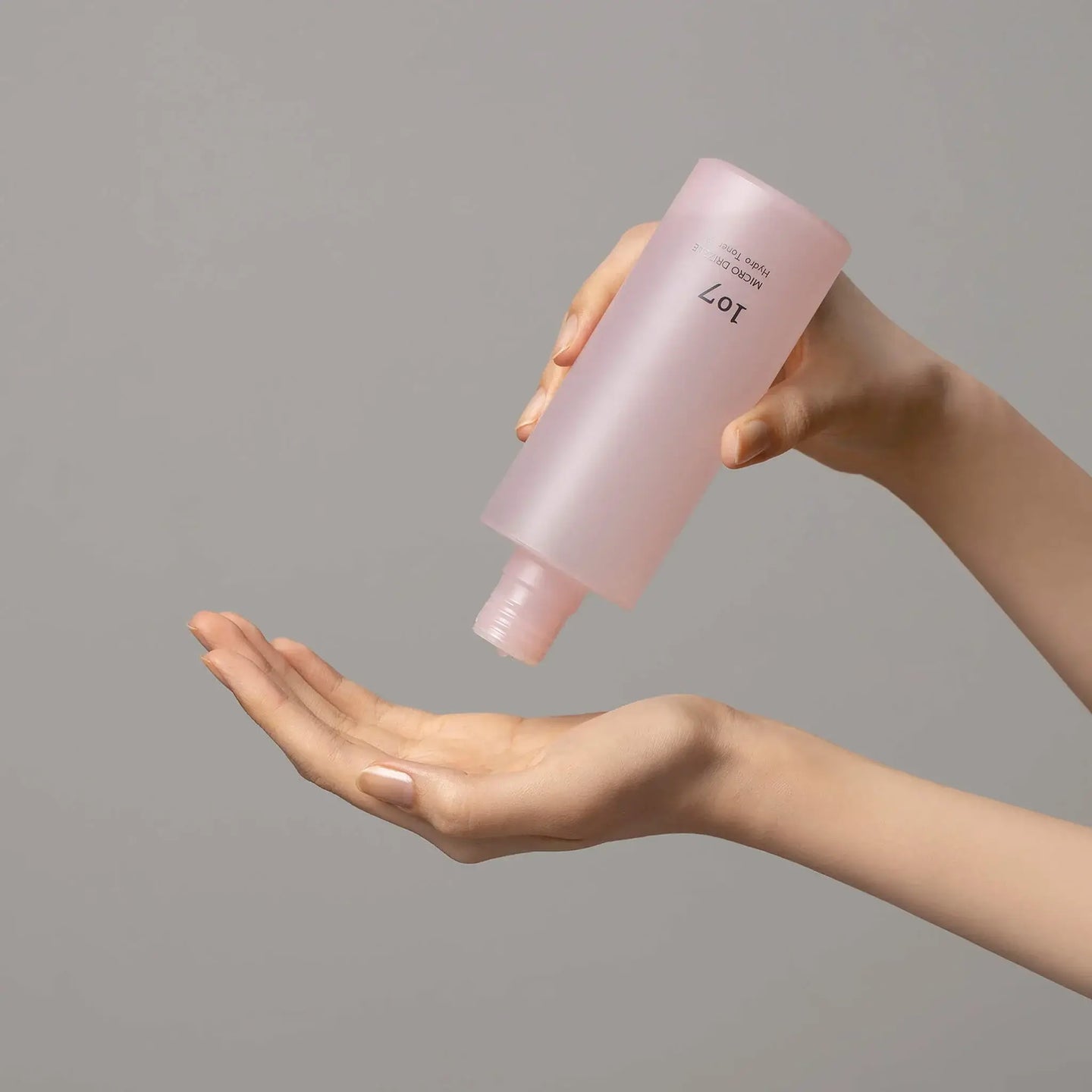 107 Micro Drizzle Hydro Toner 155ml being poured onto hand for skincare routine