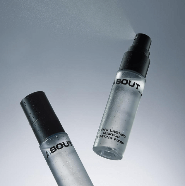 ABOUT TONE Long Lasting Makeup Coating Fixer bottles with spray mist on a grey background
