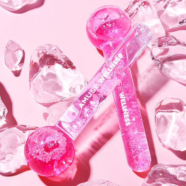 AMUSE Wellness Face Cooler, pink wellness tool surrounded by ice, enhancing facial rejuvenation and relaxation.