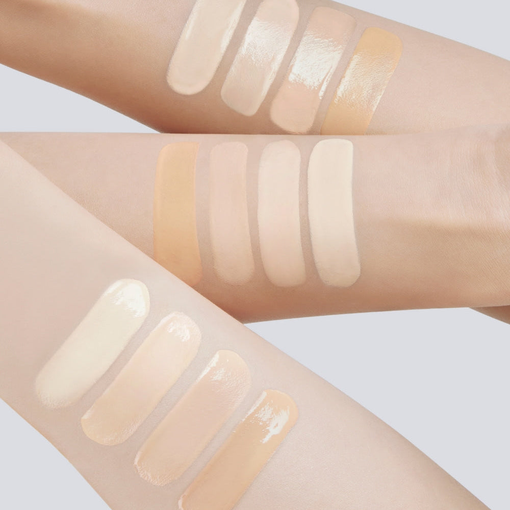Swatches of various skin tone makeup products on arms showcasing diverse color options.