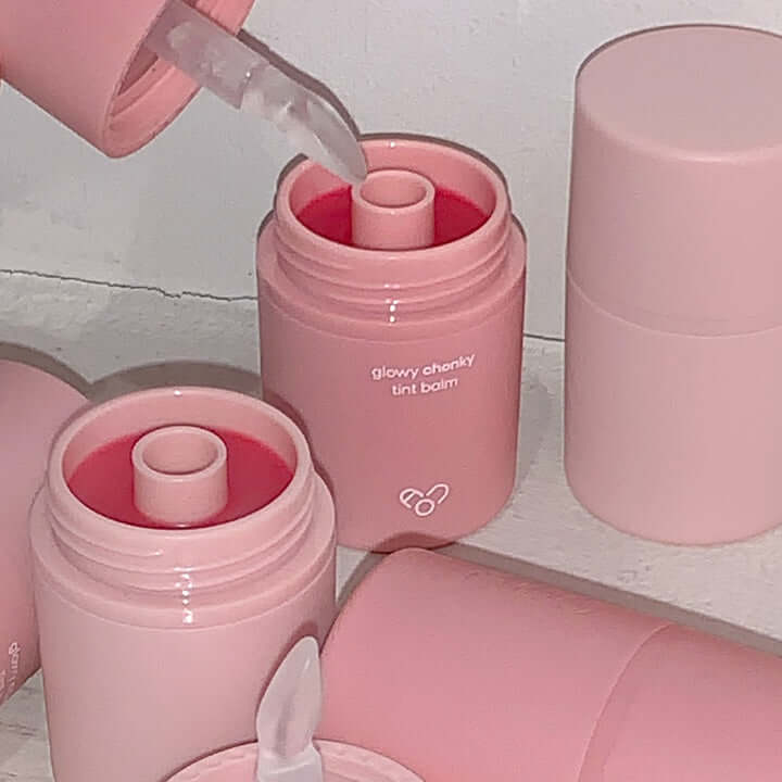 AOU Glowy Chonky Tint Balm containers showcasing the product's vibrant color and packaging.