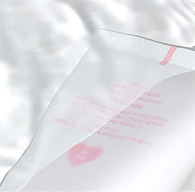 AOU Tone-Up Dazzling Cream packaging in sleek design on white satin background for brightening and radiance skincare.