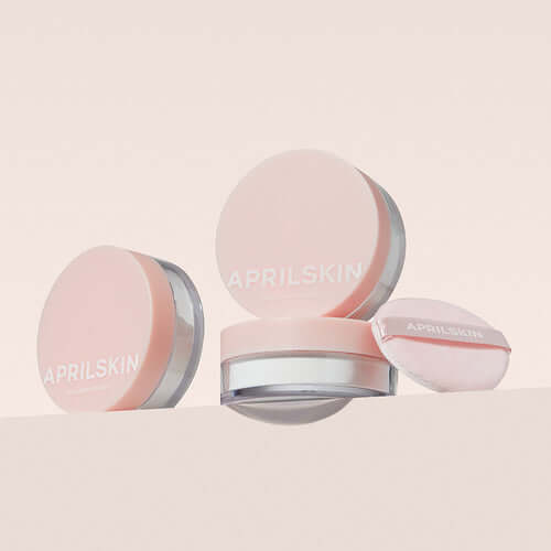APRILSKIN Blur Skin Powder in elegant pink packaging with included applicator, showcasing the smooth finish and refined design.