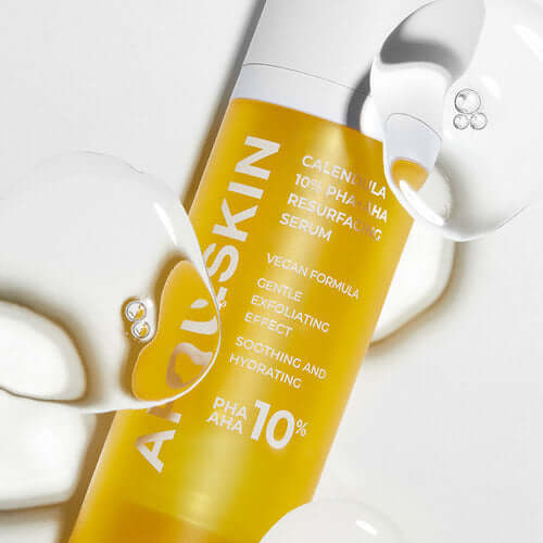 APRILSKIN Calendula 10% PHA+AHA Resurfacing Serum bottle with serum drops, vegan formula for gentle exfoliating and hydrating effect.