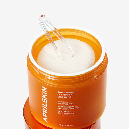 APRILSKIN Carrotene Clarifying Vita Pad container with pads and tweezers, designed to revitalize and clarify textured skin.