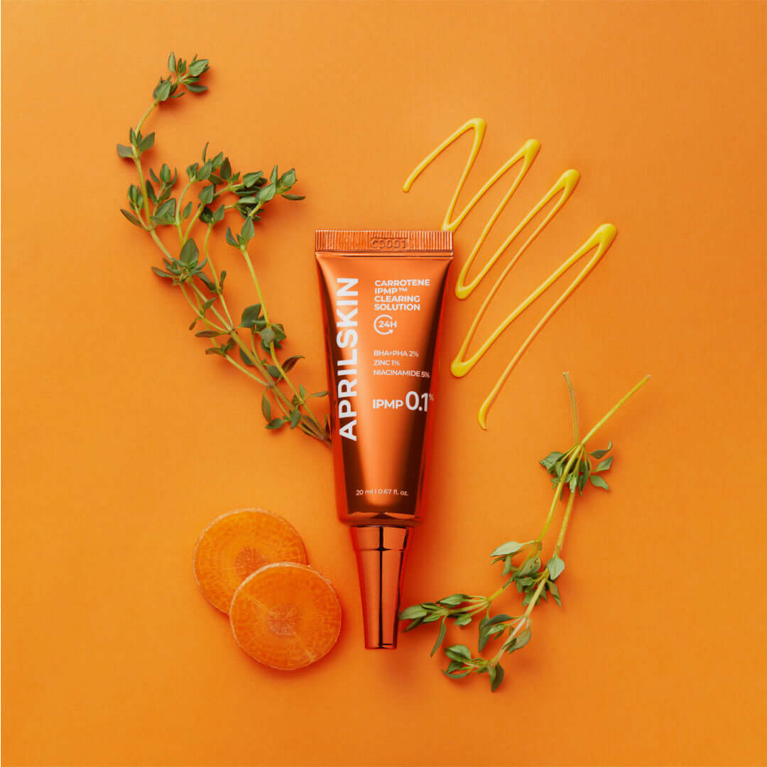APRILSKIN Carrotene IPMP Clearing Solution with orange background and natural ingredients displayed