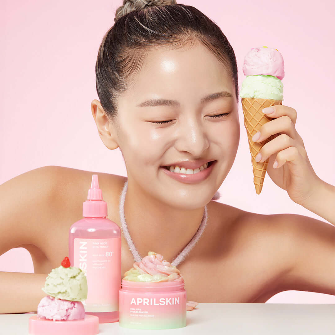 Smiling woman holding ice cream with APRILSKIN Pink Aloe Pack Cleanser on pink background