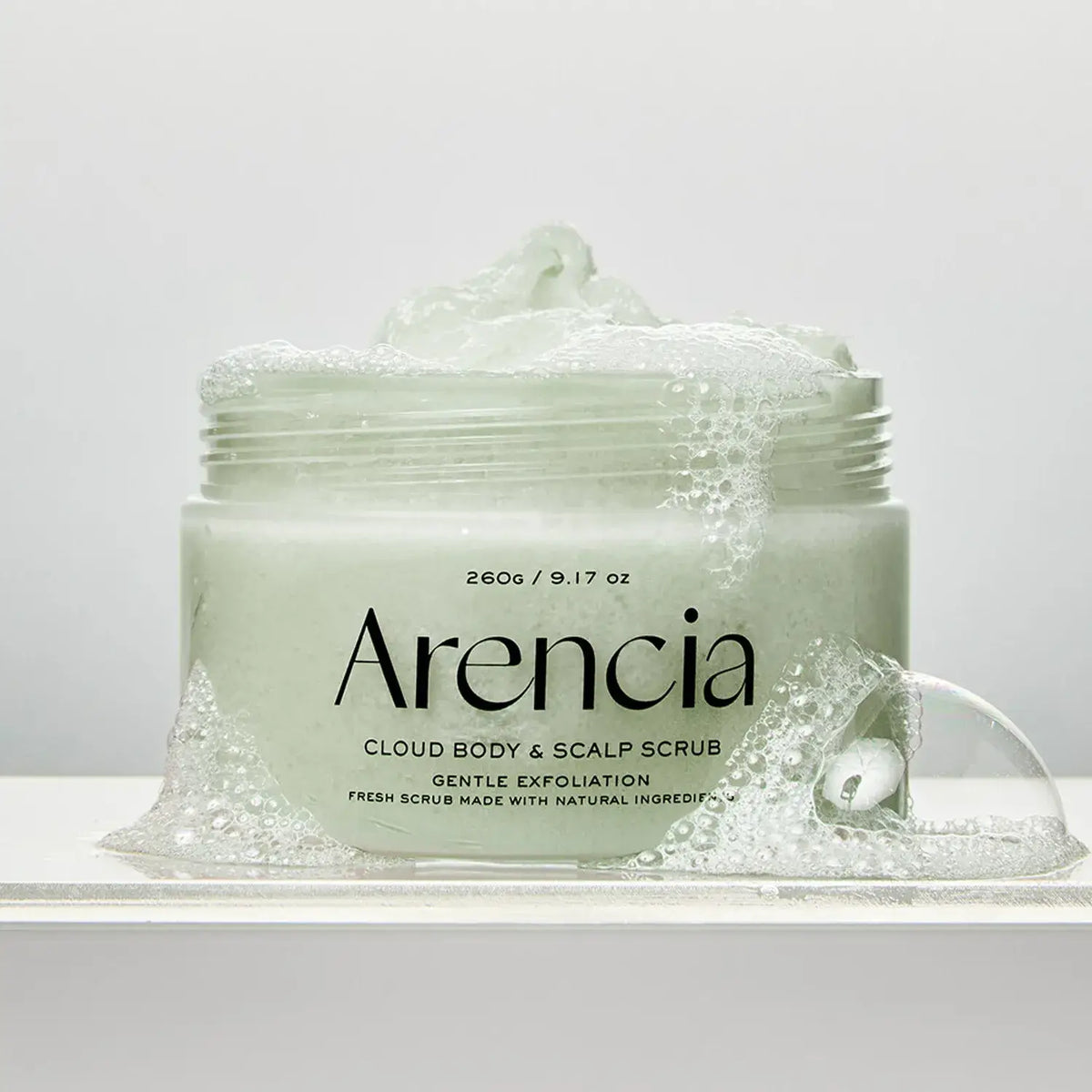 ARENCIA Fresh Cloud Body Scrub 260g jar with gentle exfoliation soap bubbles, showcasing premium skincare product for radiant skin