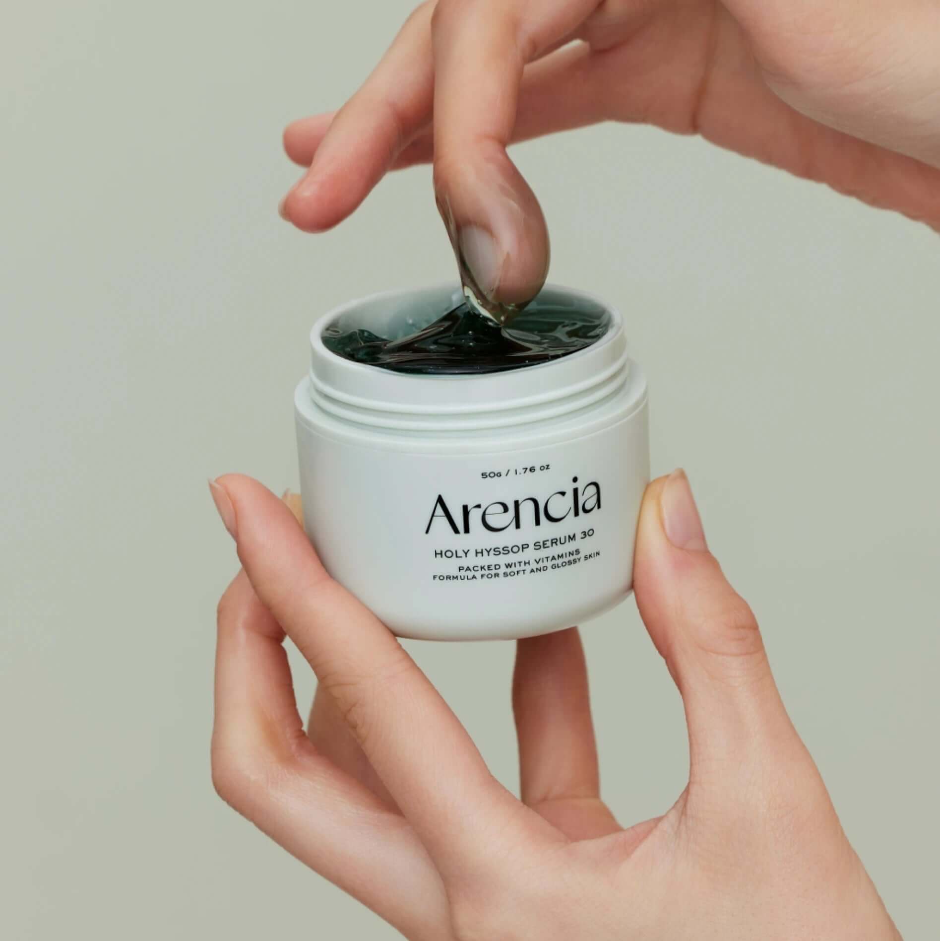 ARENCIA Fresh Holly Hyssop Serum 30 50g in hand, showing gel texture and product label.