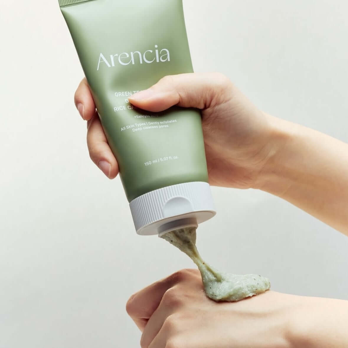 ARENCIA Green Tea + LHA Deep Pore Rice Cake Soap 150ml being applied to hand