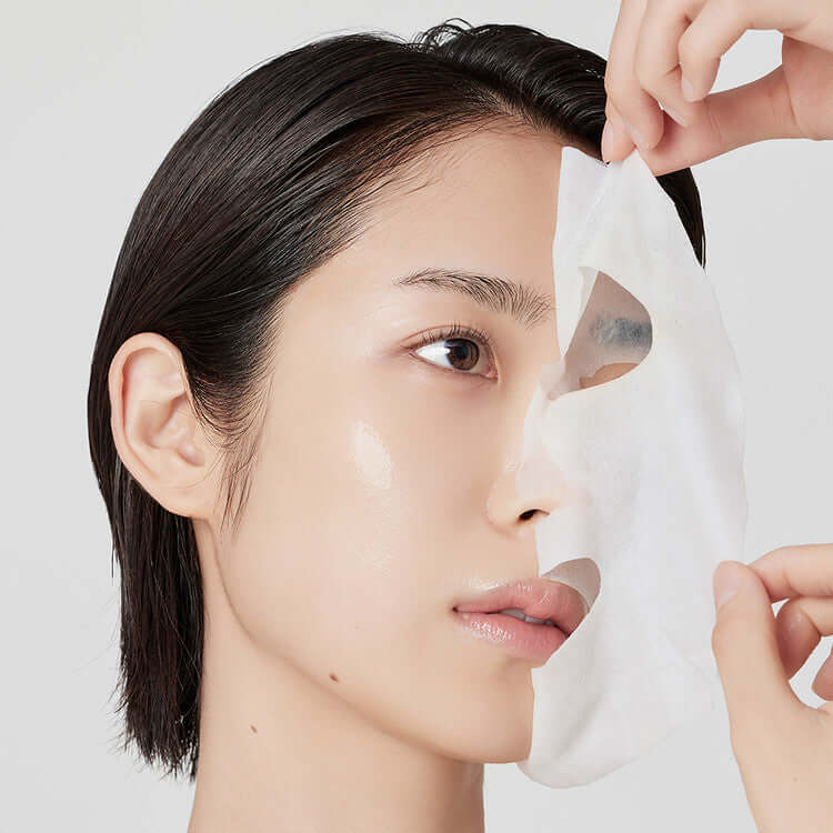 Individual applying ARENCIA Holy Hyssop Mask Pack (5 piece) sheet for skincare