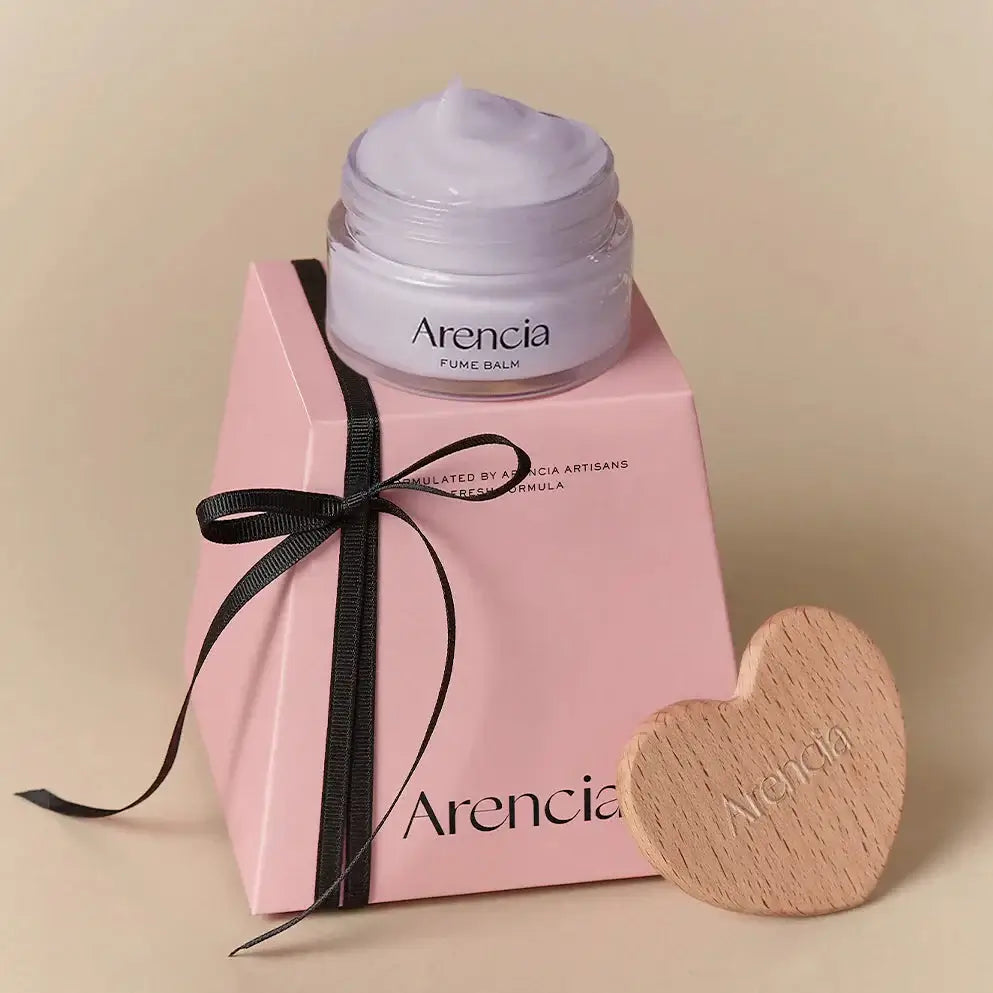 ARENCIA Hyssop Fume Balm 30g beautifully packaged with a wooden heart accessory. Skincare product in elegant presentation.