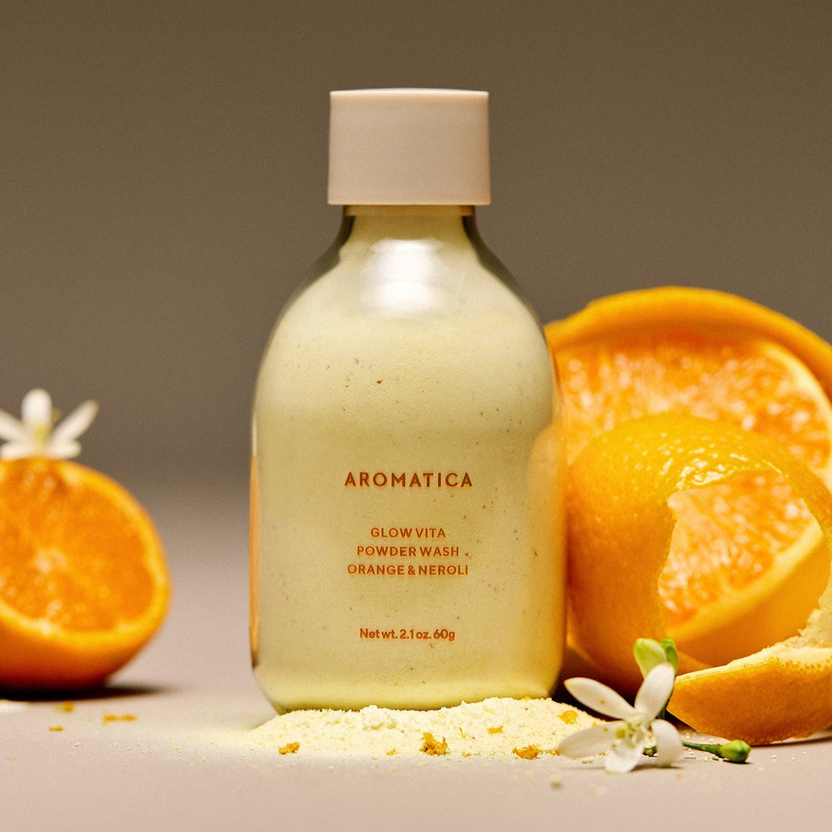 AROMATICA Glow Vita Powder Wash Orange & Neroli 60G with fresh orange halves and blossoms