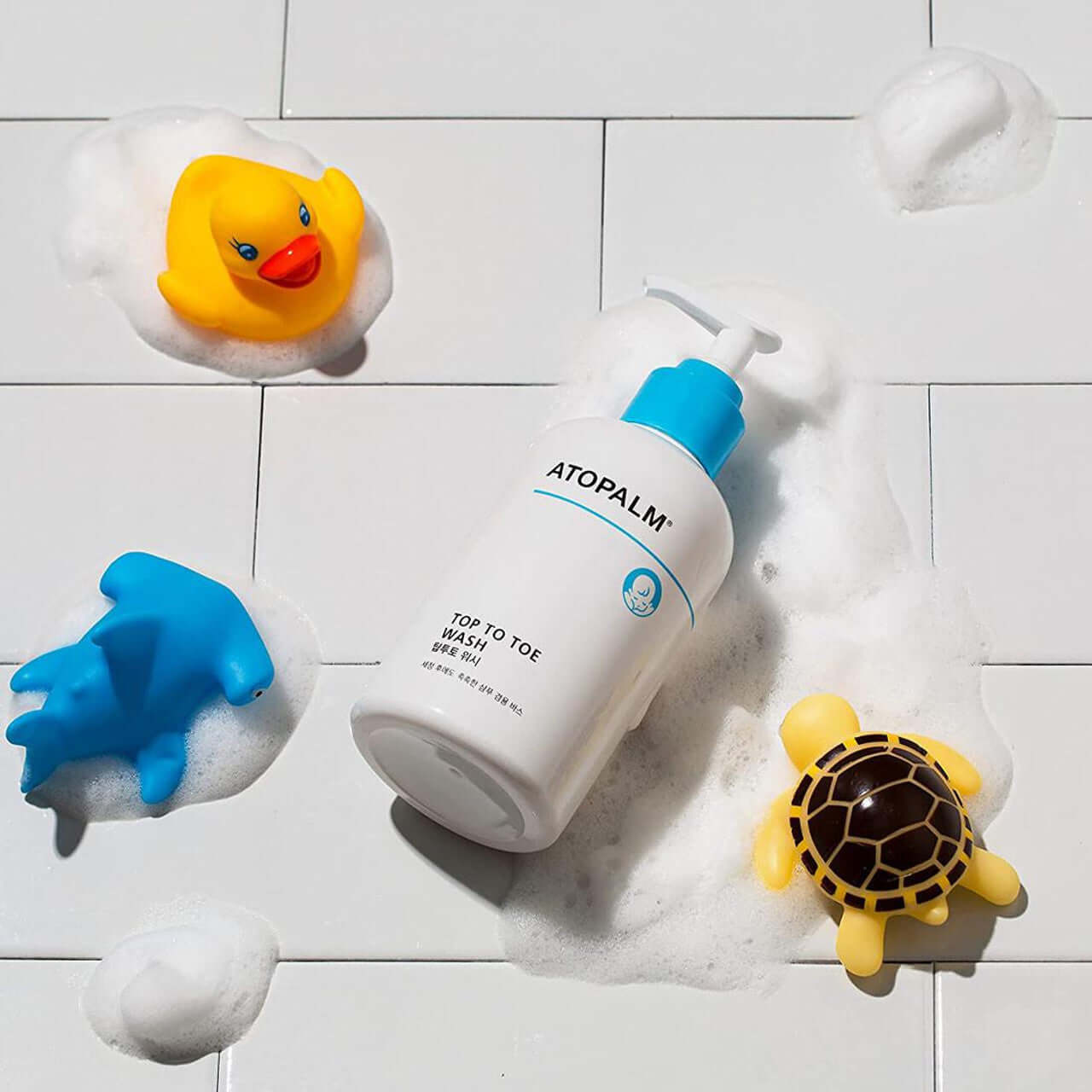 ATOPALM Atopalm Top to Toe Wash 460ml + Refill 400ml Set with foam and bath toys on a tiled surface
