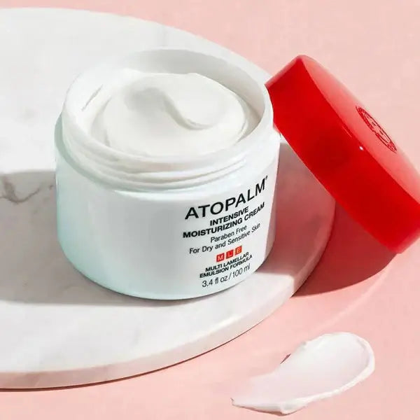 Open jar of ATOPALM MLE Cream 160ml (Single Type) with red lid on marble surface