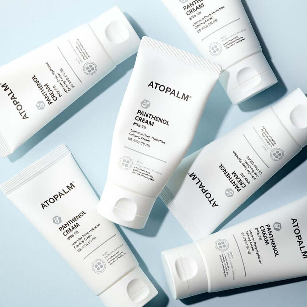 ATOPALM Panthenol Cream 80ml tubes arranged on a blue surface