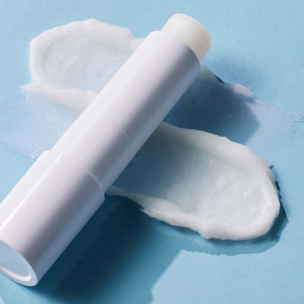 ATOPALM Panthenol Lipsera 4g lip balm on blue background