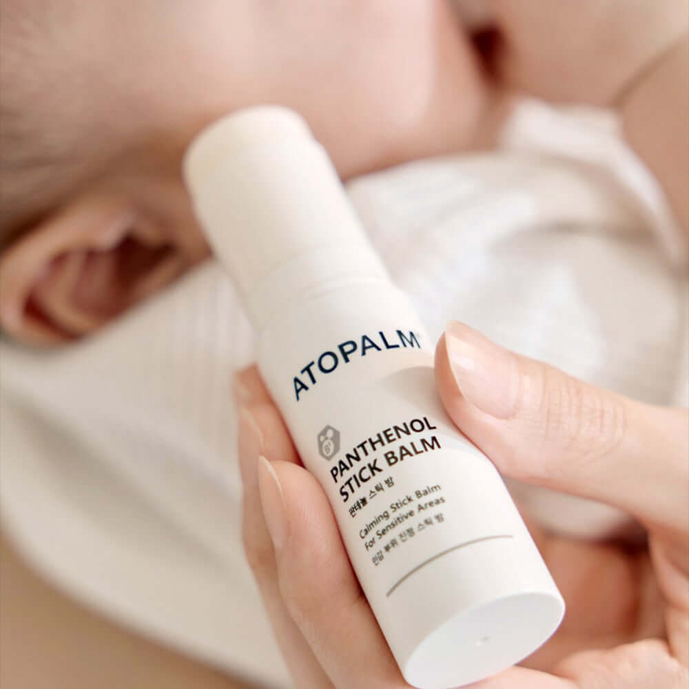 Close-up of ATOPALM Panthenol Stick Balm 10g in hand, highlighting the product design and packaging.