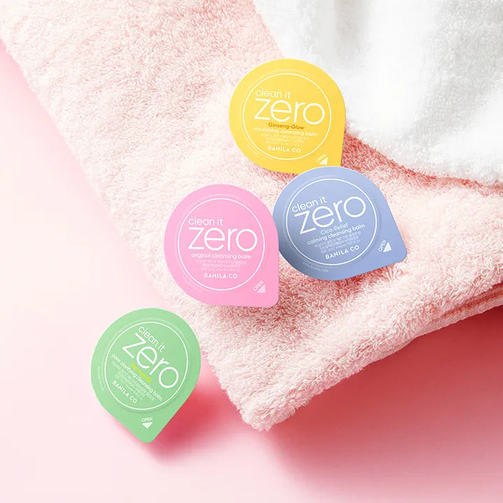 BANILA CO Clean It Zero Cleansing Balm Variety Travel Kit Duo Set with colorful balm pods on a soft pink towel