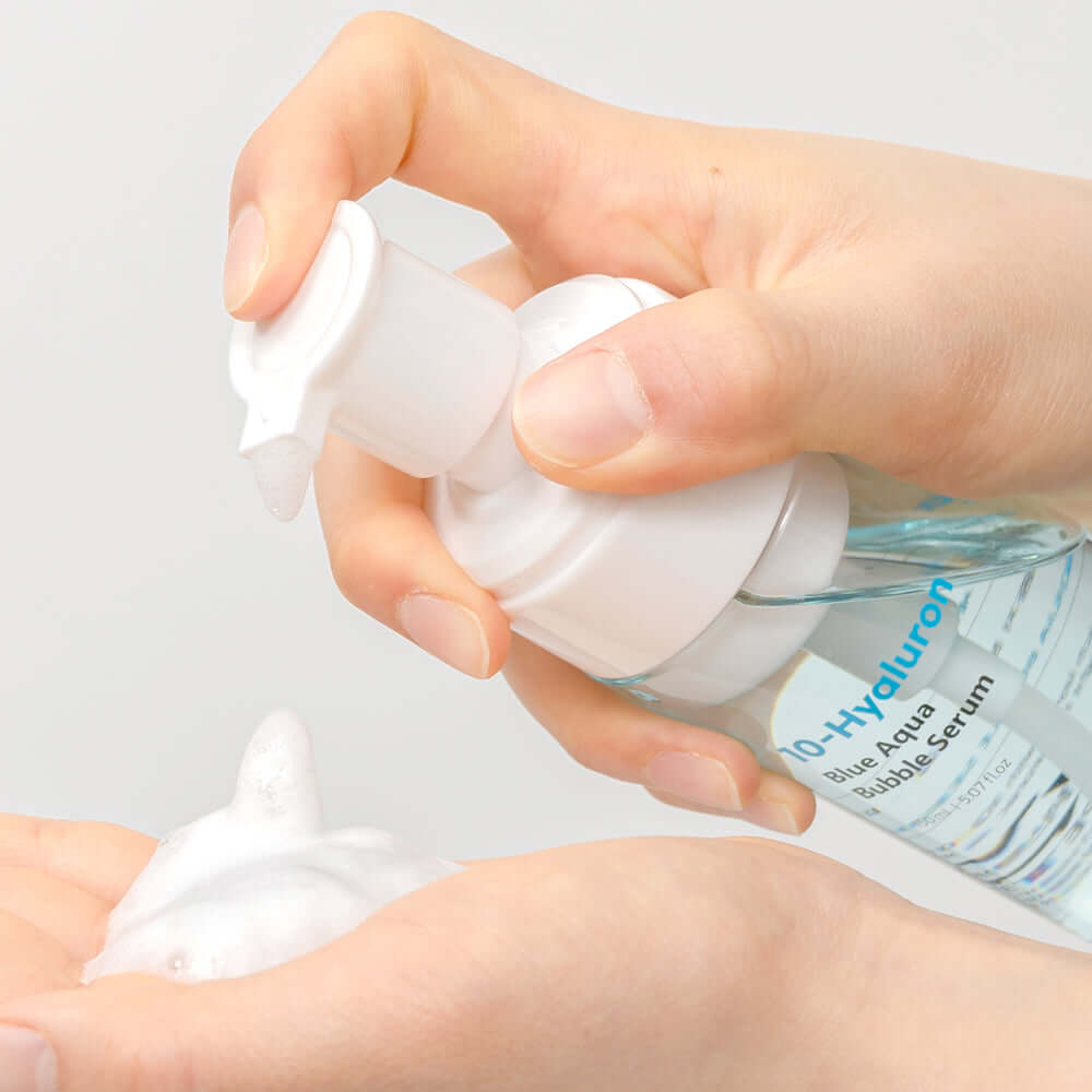 Hands using BARULAB 10-Hyaluronic Acid Blue Aqua Bubble Serum pump to dispense foam product