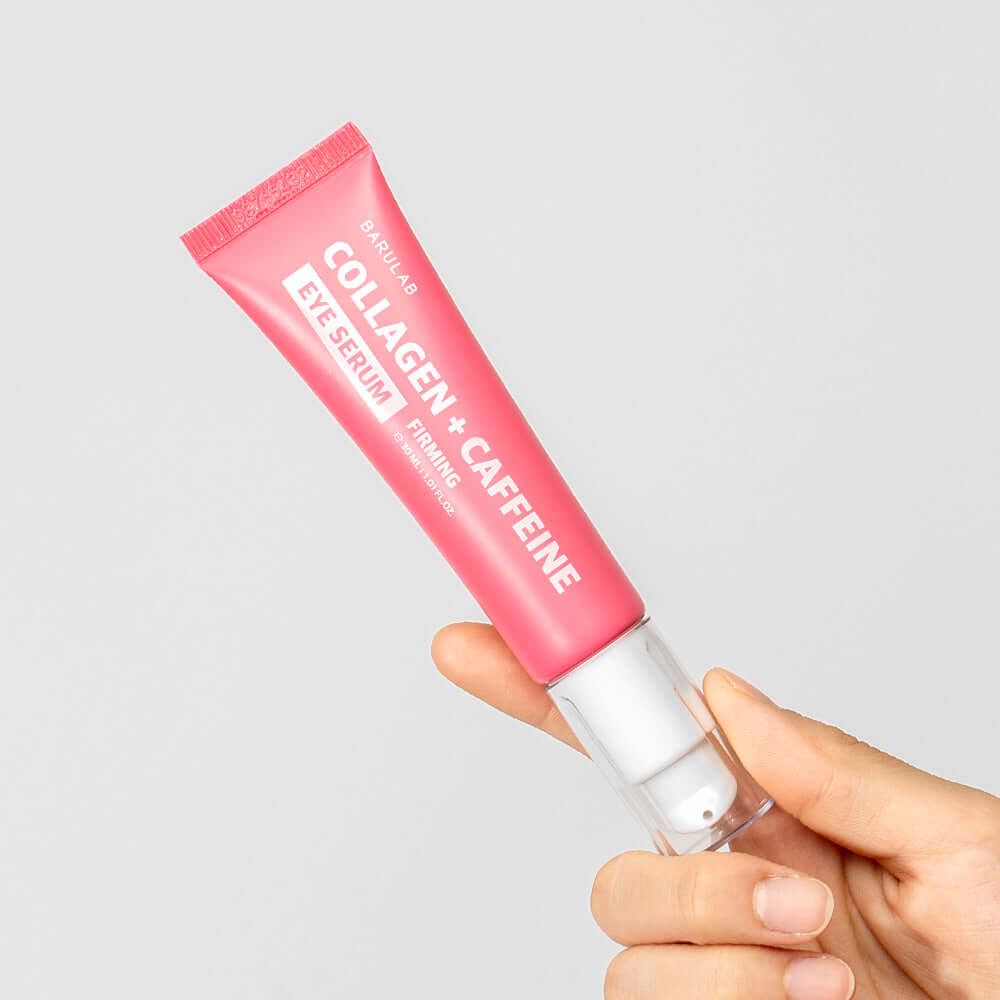 BARULAB Collagen Caffeine Elasticity Eye Serum 30ml in a pink tube held by a hand, showcasing product packaging and design.