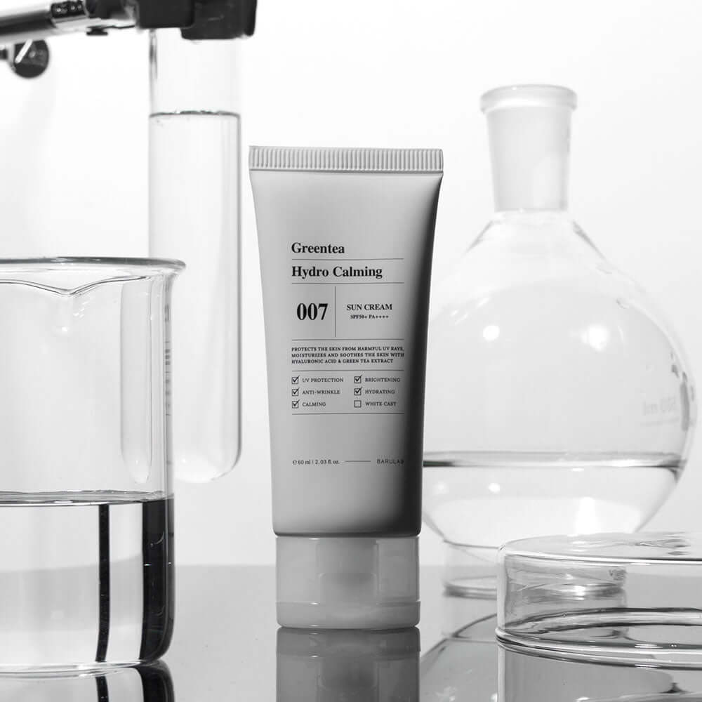 BARULAB Green Tea Hydro Calming Sun Cream tube surrounded by lab glassware