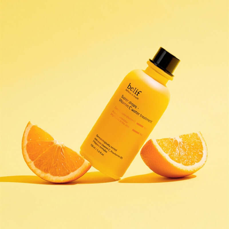 BELIF Super Drops-Vitamin C Water Treatment 150ml bottle with sliced oranges on a yellow background