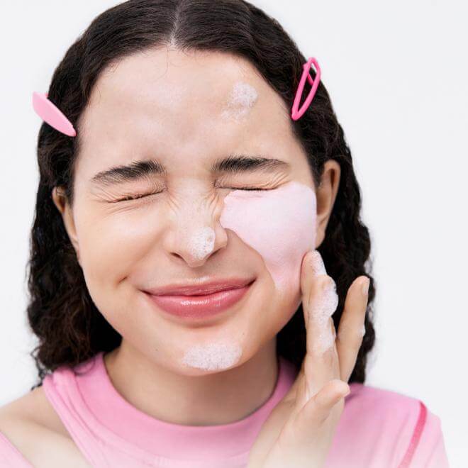 Woman applying BELIF Super Knights Pore Fiming Vegan Pack Cleanser 150ml on face.