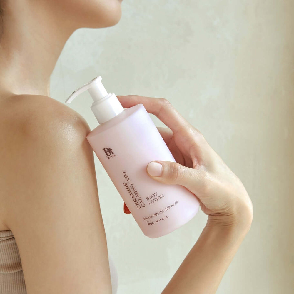 Person applying BENTON Ceramide Calming Ato Body Lotion 300ml on shoulder