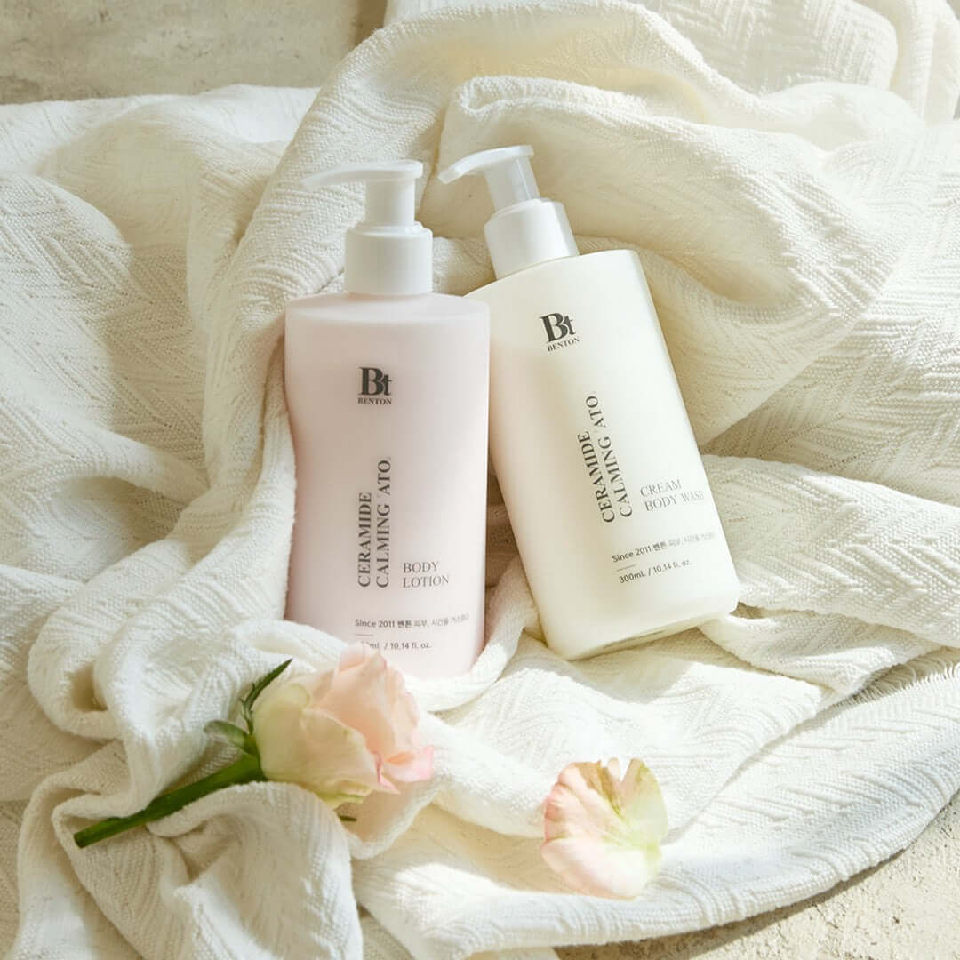 BENTON Ceramide Calming Ato Cream Body Wash 300ml and Body Lotion displayed elegantly with flowers on fabric