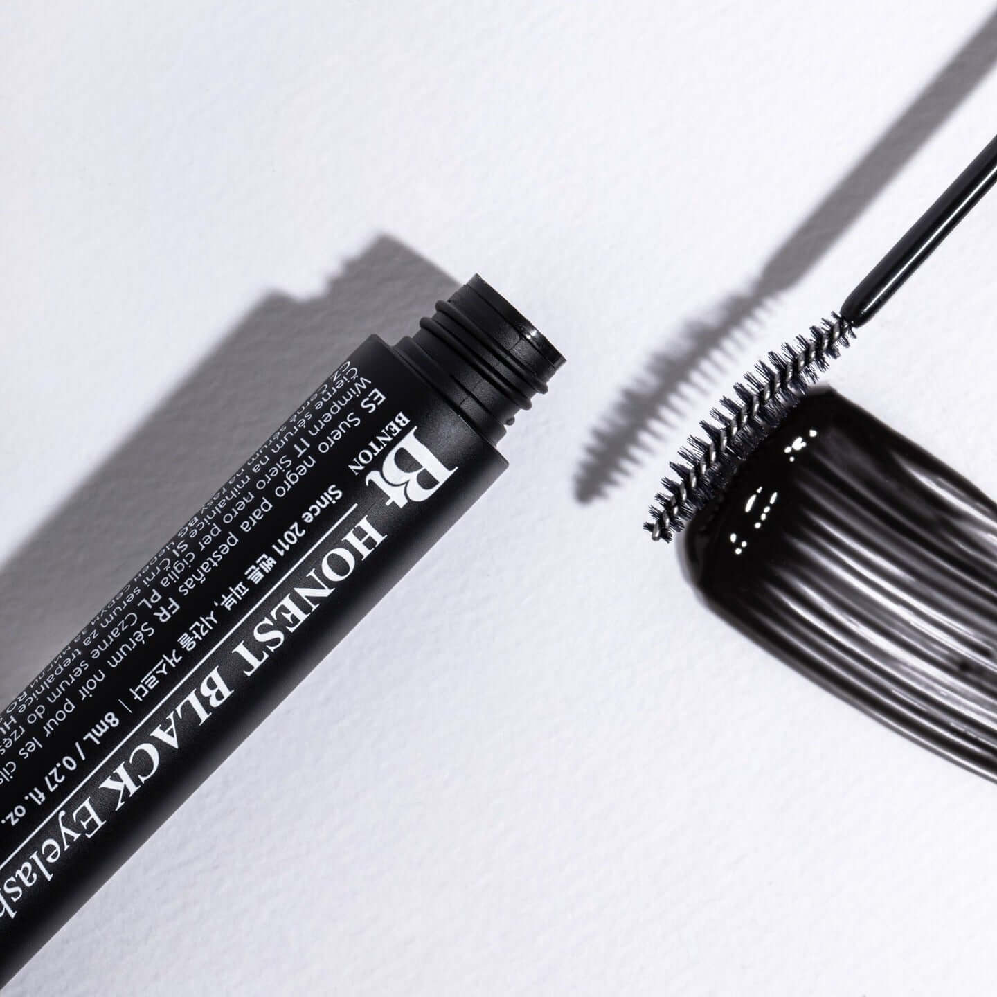 BENTON Ernest Black Eyelash Nutrient 8ml mascara with brush applicator on white background.
