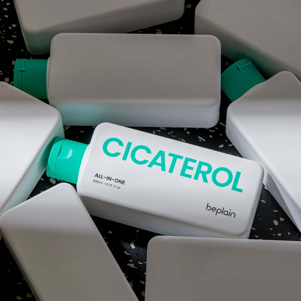 BEPLAIN Cicaterol All-in-one skincare product with green caps displayed on a dark speckled surface, highlighting the brand name.