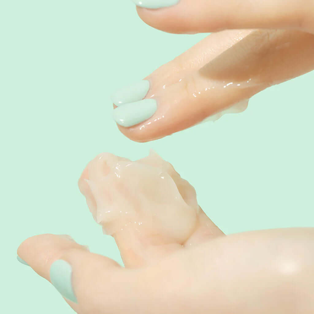 Application of BEPLAIN Cicaterol Cream on fingers against a green background.