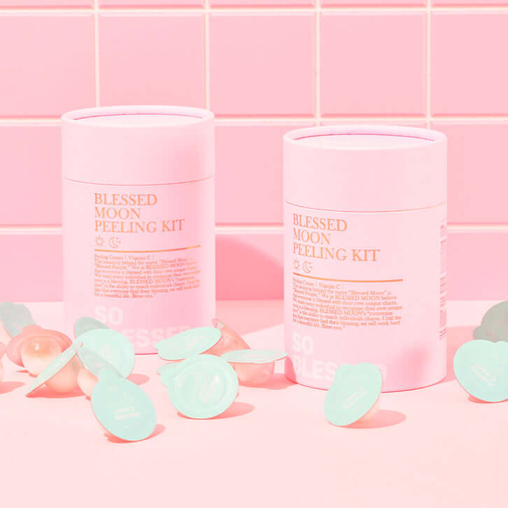 BLESSED MOON Pelling Kit in pink packaging with scattered individual use pods, displayed against a pink tile background.