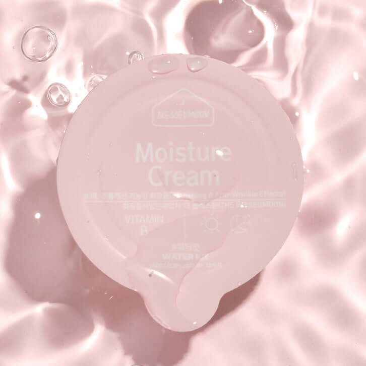 BLESSED MOON Water Kit moisture cream on pink water surface with reflections and bubbles for skincare and hydration.