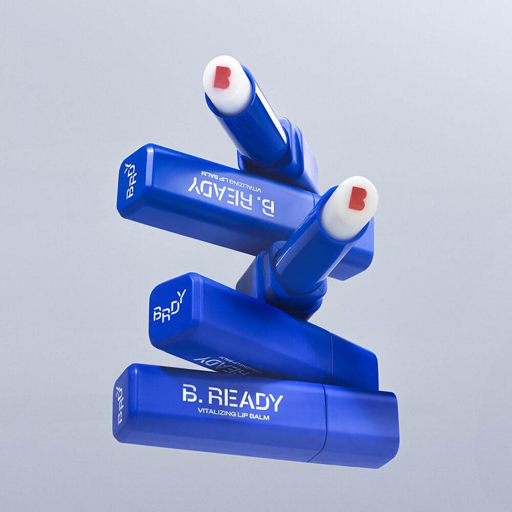 B.READY Vitalizing Lip Balm tubes stacked, showcasing vibrant design and logo for lip care.
