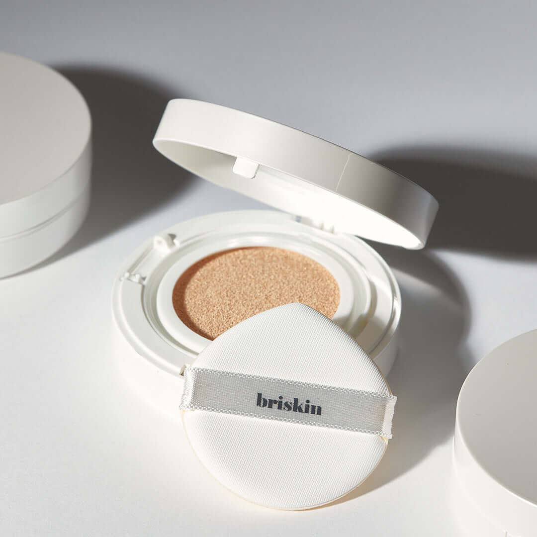 BRISKIN Exo-Glow Secondskin Cushion 15g open with applicator, highlighting its light-reflecting formula for a radiant complexion.