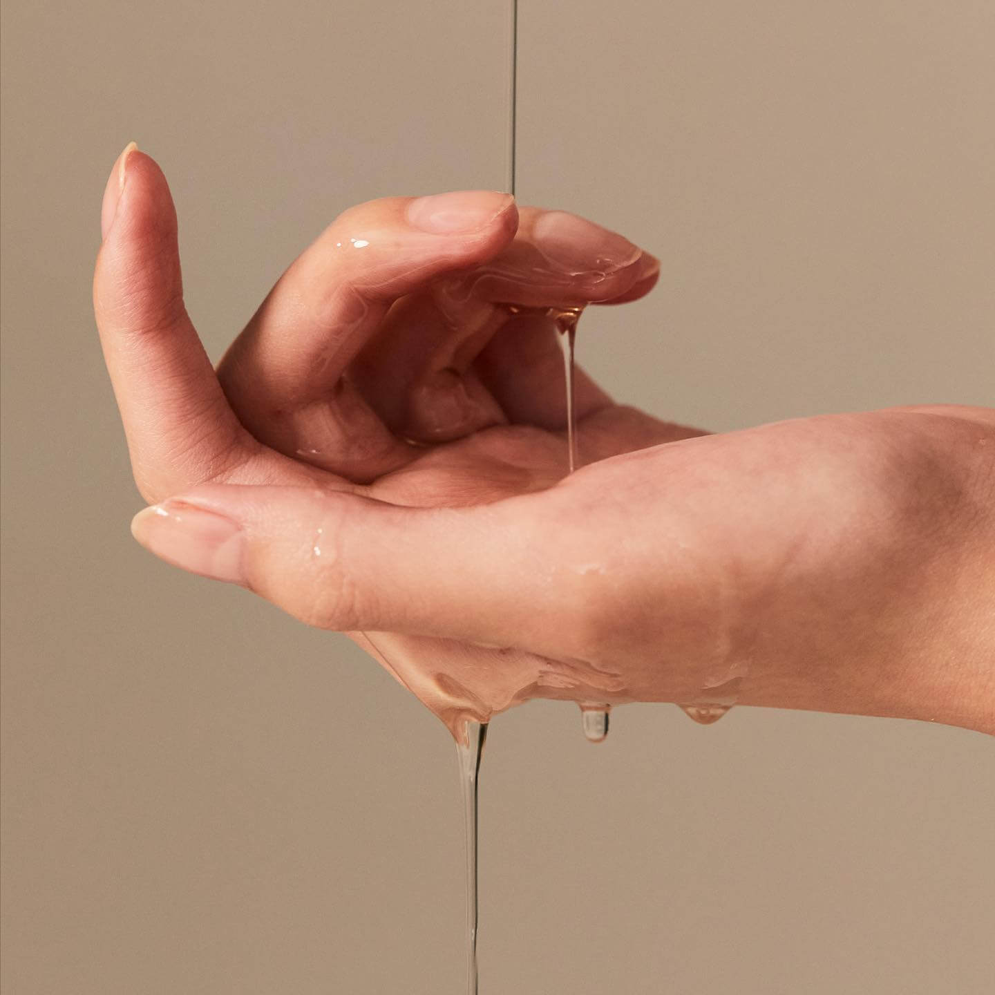 Person applying BRISKIN Exo-Oat Poreless Cleansing Oil 200ml on hands.