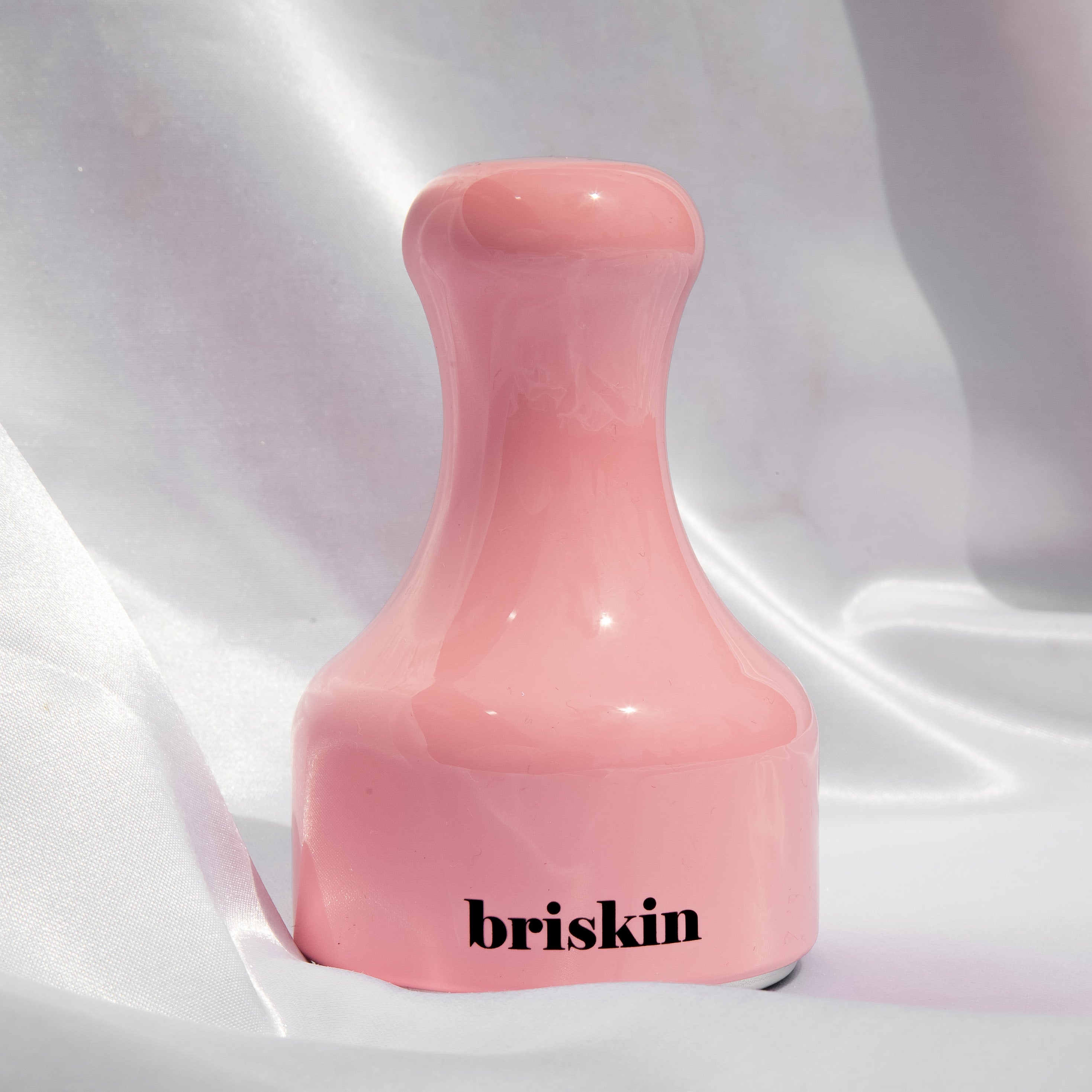 BRISKIN Face & Body Calming Ice Therapy pink tool on fabric