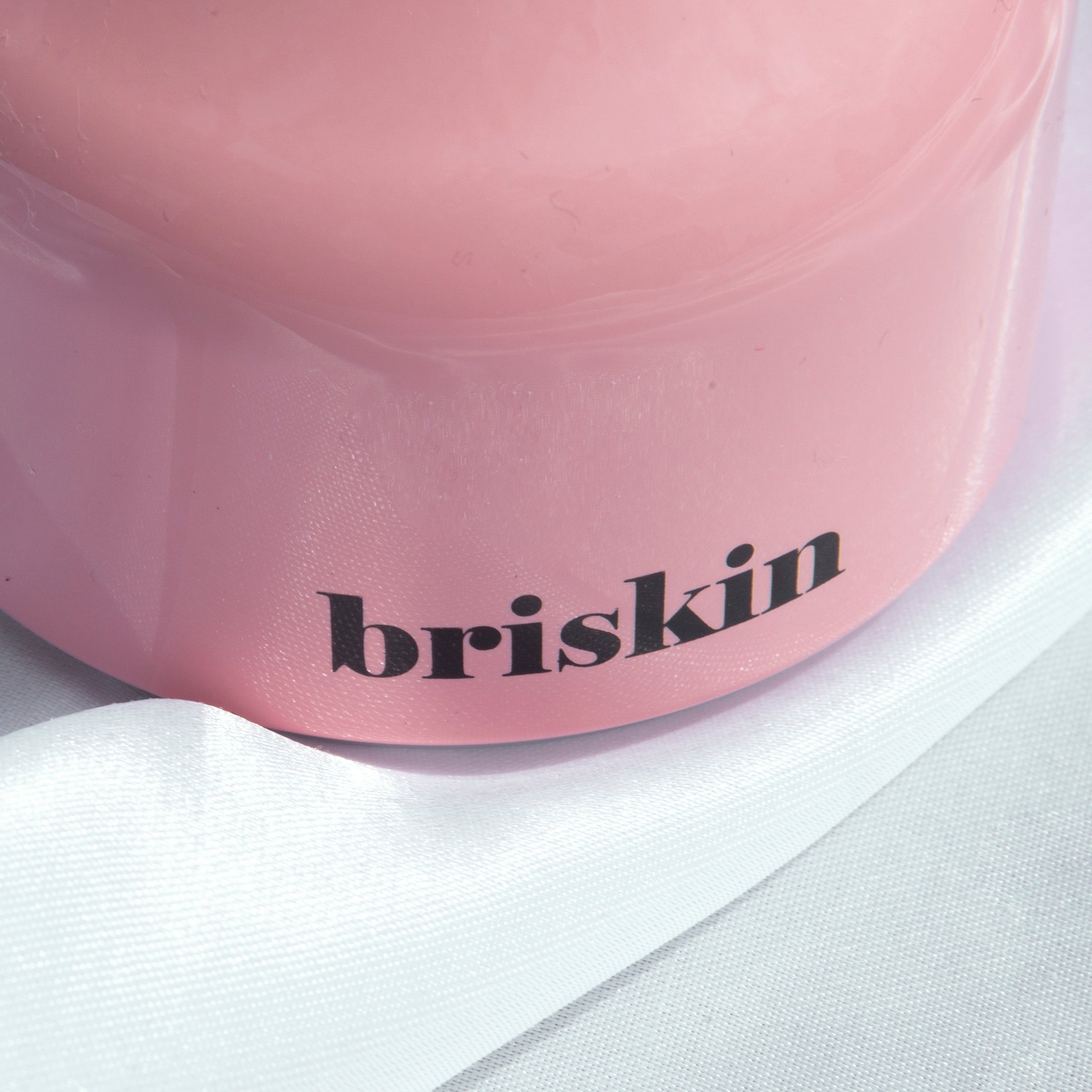 BRISKIN Face & Body Calming Ice Therapy in pink container with elegant design, showcasing the brand name "briskin" prominently.