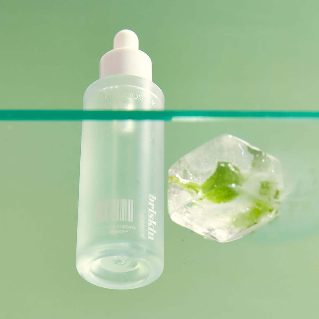 BRISKIN Houttuynia Cordata Exo-Barrier Skinbooster Serum 50ml next to green plant and ice cube on mint background