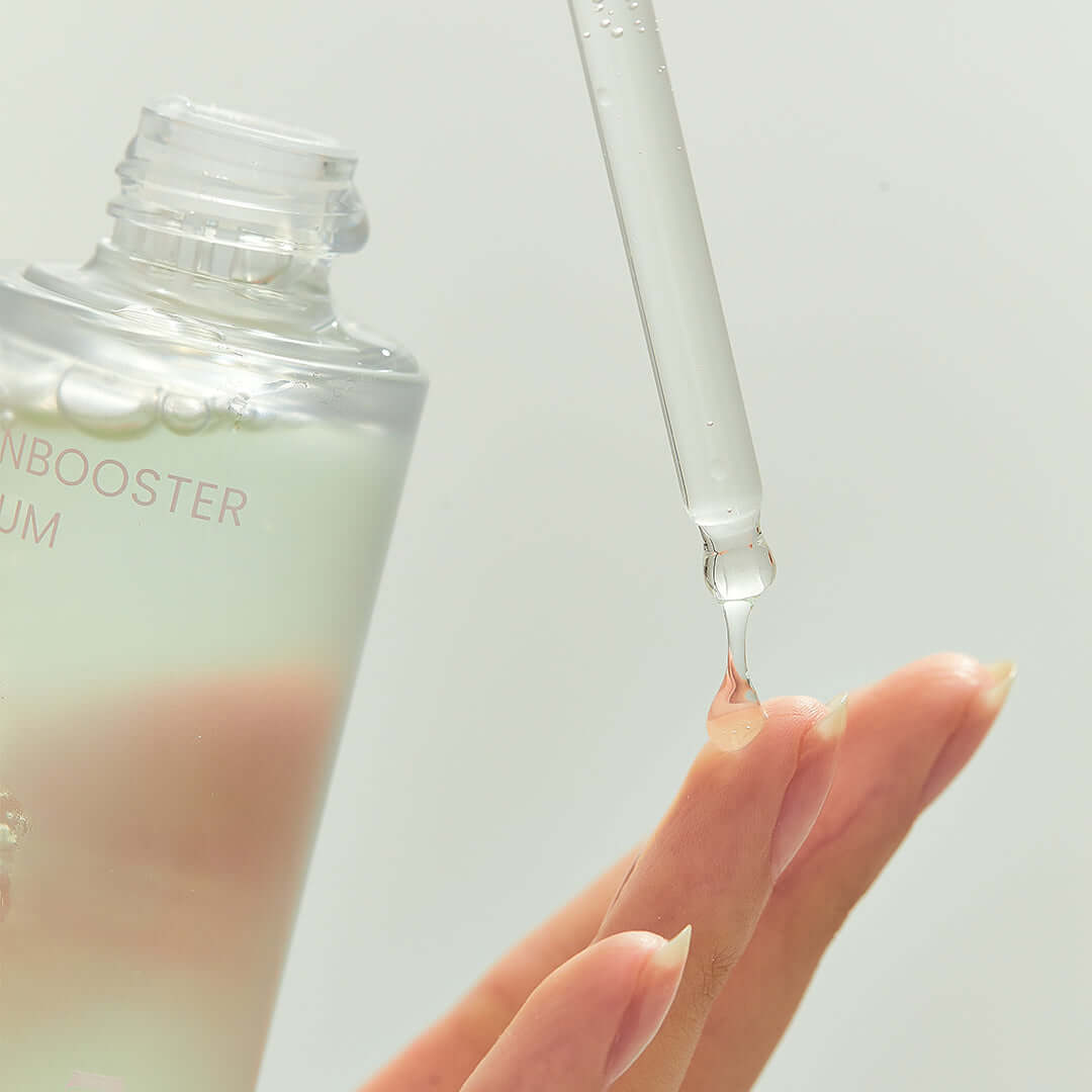 Close-up of BRISKIN Houttuynia Cordata Exo-Barrier Skinbooster Serum 50ml being applied with a dropper to fingertips.