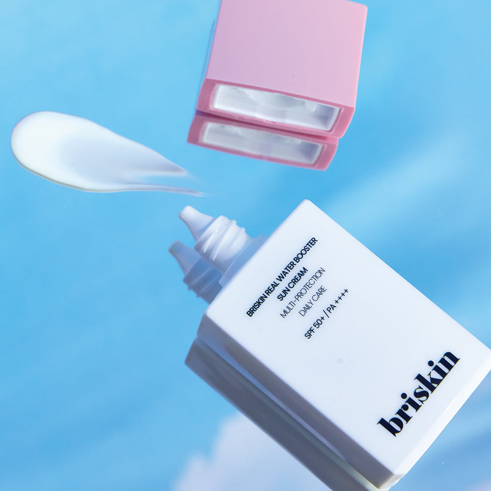 BRISKIN Real Water Booster Sun Cream SPF+PA++++ 50ml with opened cap on a reflective surface.