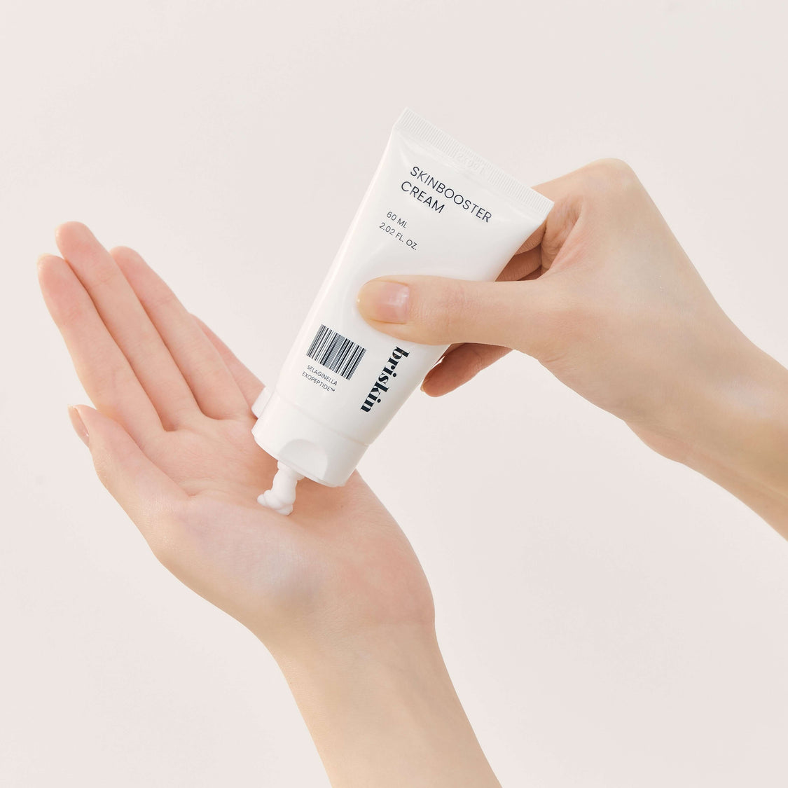 Person applying BRISKIN Selaginella Exopeptide Skin Booster Cream 60ml on hand.