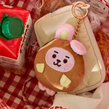 BT21 Bakery Plushy Keyring with cute design on a picnic setup.